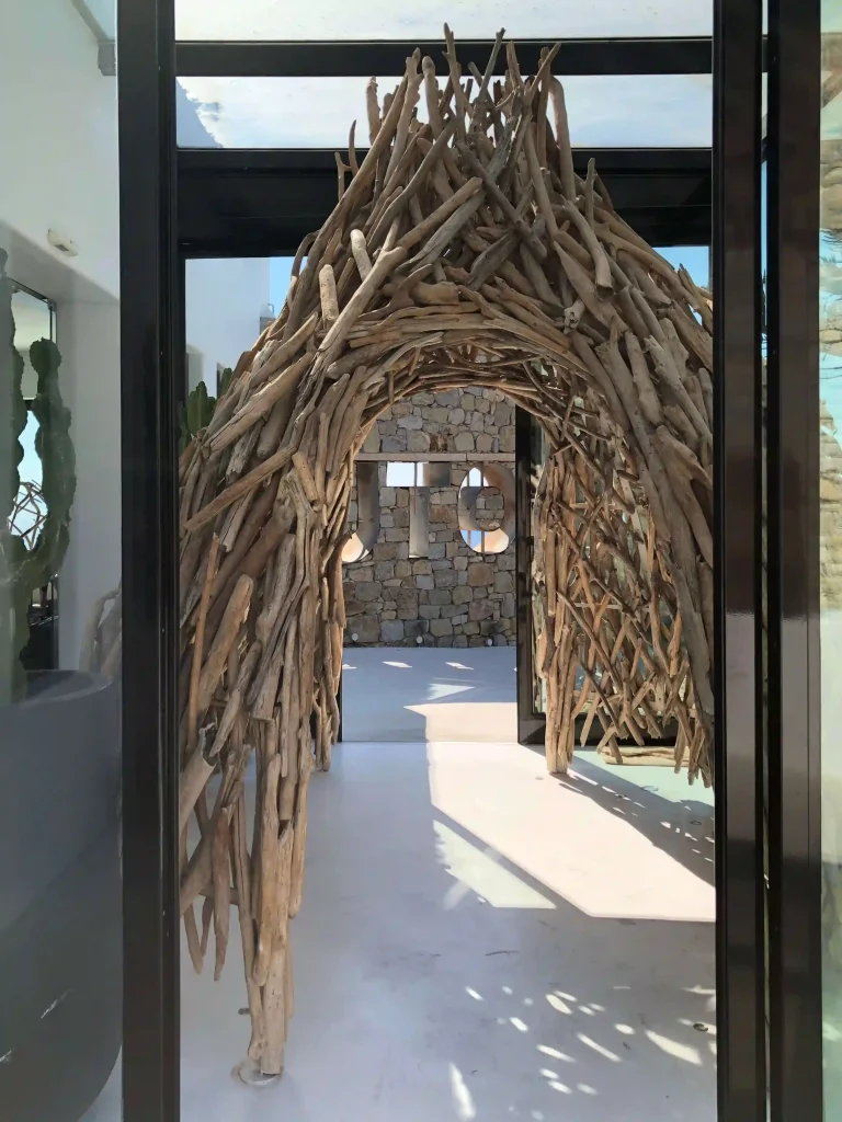 Inviting wooden archway at the entrance of a serene space.